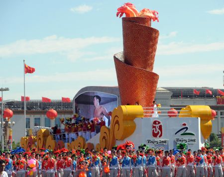 A float depicting the 2008 Beijing Olympics takes part in a parade of the celebrations for the 60th anniversary of the founding of the People&apos;s Republic of China, on Chang&apos;an Street in central Beijing, capital of China, Oct. 1, 2009. (Xinhua/Xu Yu)