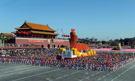 The float featuring Beijing Olympics takes part in a parade of the celebrations for the 60th anniversary of the founding of the People&apos;s Republic of China, in Beijing, capital of China, Oct. 1, 2009. (Xinhua/Chen Shugen)