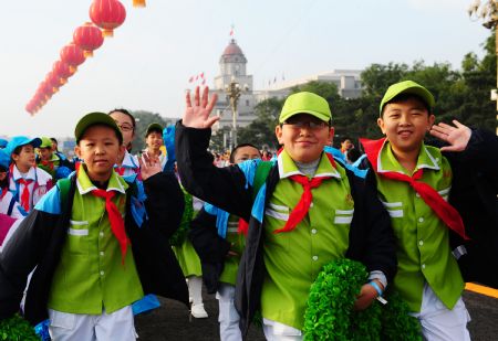 Pupils attending the celebrations for the 60th anniversary of the founding of the People's Republic of China, walk into the Tian'anmen Square in central Beijing, capital of China, Oct. 1, 2009. (Xinhua/Ren Yong)