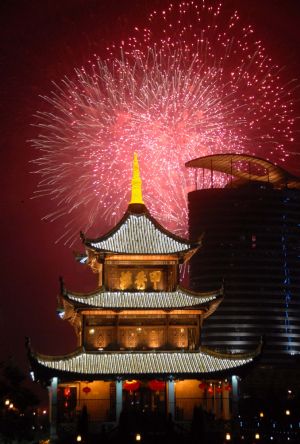 Scintillant firework flare up and flash over the Jiaxiulou Tower, the city's landmark ancient building for sightseeing, during a grand firework celebration of the 60th anniversary of the founding of the People's Republic of China, in Guiyang, southwest China's Guizhou Province, September 30, 2009.