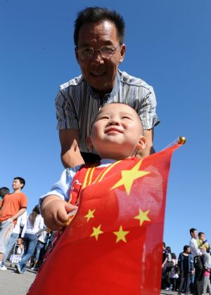 A man accompanies his grandson to tour the Tian'anmen Square in central Beijing, capital of China, on Oct. 3, 2009.(Xinhua/Yang Zongyou)