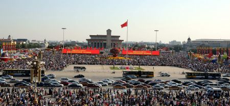 Large crowds of tourists view floats at the Tian'anmen Square in central Beijing, capital of China, Oct. 2, 2009. The floats took part in the parade marking the 60th anniversary of the founding of the People's Republic of China in Beijing on Oct. 1. (Xinhua/Fan Jiashan)