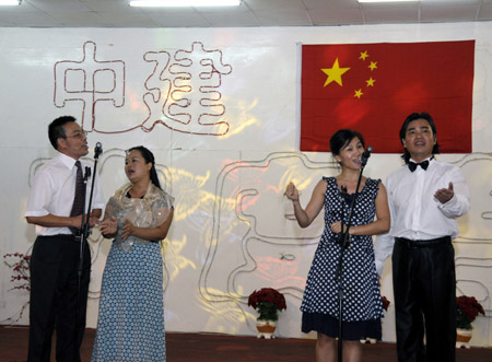 Workers from the China State Construction Engineering Corporation (CSCEC) perform a quartet during an evening party in Dubai of UAE, October 3, 2009. 