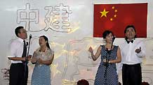 Workers from the China State Construction Engineering Corporation (CSCEC) perform a quartet during an evening party in Dubai of UAE, October 3, 2009.