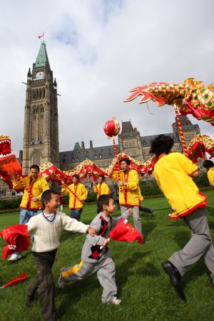 Dragon dancers perform during a gathering to celebrate the 60th anniversary of the founding of the People's Republic of China in central Ottawa, Canada on October 3, 2009. 