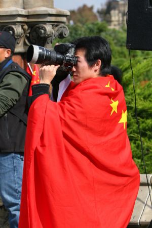 An overseas Chinese takes photos during a gathering to celebrate the 60th anniversary of the founding of the People's Republic of China in central Ottawa, Canada on October 3, 2009.