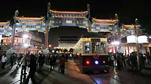 A 'Dangdang car', the old-fashioned trolley car, runs on Qianmen Street, one of the old commercial areas of Beijing, capital of China, October 3, 2009. The reopened Qianmen Street attracted a lot of tourists during the National Day holidays, which overlaps the traditional Mid-Autumn Festival this year.