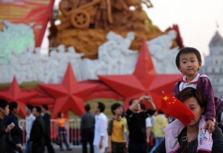 A child views floats on display at Tian'anmen Square in central Beijing, capital of China, October 5, 2009. China's travel authorities reported a 700-percent rise in tourist arrivals around the Tian'anmen Square on Monday.