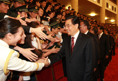 Chinese President Hu Jintao (R, front), also general secretary of the Communist Party of China (CPC) Central Committee, shakes hands with delegates of organizers and performers of the grand celebrations of the 60th founding anniversary of the People's Republic of China held on Oct. 1, in Beijing, China, on Oct. 6, 2009. The other eight members of the Standing Committee of the Political Bureau of the CPC Central Committee, including top legislator Wu Bangguo and Premier Wen Jiabao, also attended the meeting. (Xinhua/Ju Peng)