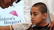 A paramedical worker sprays influenza H1N1 vaccine into Brundan Marty's nose at the Children's Hospital at Montefiore during an event marking the beginning of the city-wide H1N1 vaccination program in New York, the US, October 6, 2009. The initial allocation of 68,000 doses in nasal spray form started reaching health care providers on Monday.