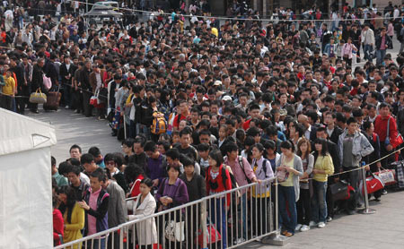 Passengers queue to receive security check at the subway station entrance of Beijing Railway Station in Beijing, capital of China, October 7, 2009. As the National Day holidays are about to end, the railway transportation witnessed a travel peak all over the nation.