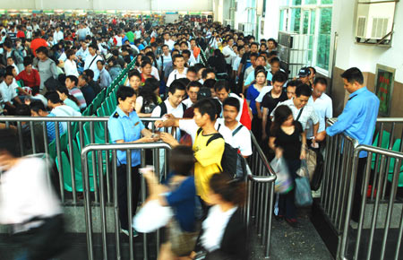 Passengers walk out of Beijing Railway Station in Beijing, capital of China, October 7, 2009. As the National Day holidays are about to end, the railway transportation witnessed a travel peak all over the nation.