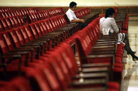 Staff members test the equipment for simultaneous interpretation at the venue of the World Media Summit at the Great Hall of the People in Beijing, capital of China, on October 8, 2009.