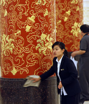 A staff member does the cleaning work at the venue of the World Media Summit at the Great Hall of the People in Beijing, capital of China, on October 8, 2009. The preparation work was all done for the World Media Summit, which will be opened here on Friday morning with the attendance of heads of 135 media organizations from more than 70 countries and regions.