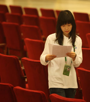 A volunteer checks seating arrangements at the venue of the World Media Summit at the Great Hall of the People in Beijing, capital of China, on October 8, 2009.