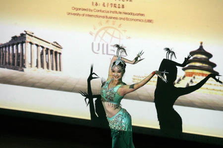 A Chinese student dances at the opening ceremony for the first Confucius Institute in Greece in Athens, capital of Greece, October 8, 2009.