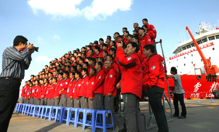 Members of China's 26th Antarctic exploration team take a group photo before get on board in Shanghai, China, October 10, 2009.