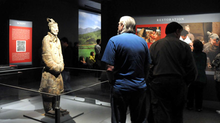 Visitors admire the displayed terra cotta warrior at the Houston Museum of Natural Science in Houston, the United States, on October 18, 2009.