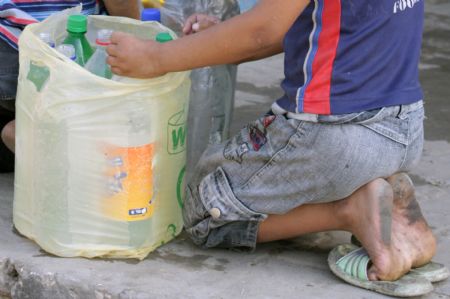 A Palestinian boy arranges plastic bottles to fetch drinking water in the southern Gaza Strip town of Rafah October 21, 2009. 