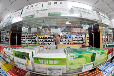 A man put medicine on the shelf in a drug store in Yinchuan, northwest China's Ningxia Hui Autonomous Region, October 22, 2009.
