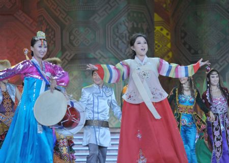 Actors sing 'Flying Songs on Earth' in different ethnic languages during an evening gala marking the open of the 11th Nanning International Folk Song Arts Festival in Nanning, capital of southwest China's Guangxi Zhuang Autonomous Region, October 20, 2009.