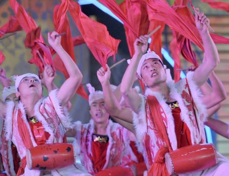 Actors perform Ansai Drums during an evening gala marking the open of the 11th Nanning International Folk Song Arts Festival in Nanning, capital of southwest China's Guangxi Zhuang Autonomous Region, October 20, 2009.