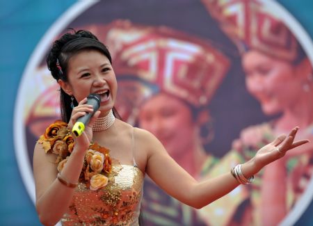 An actor performs folk song of the Zhuang ethnic group during a 'Harmonious Nanning, Joyous Green City' activity in Nanning, capital of southwest China's Guangxi Zhuang Autonomous Region, October 22, 2009. 