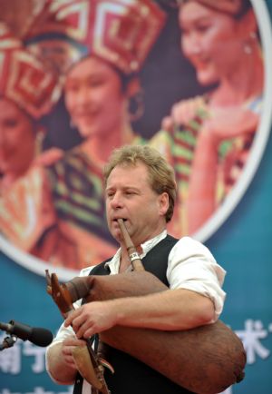 A Hungary artist plays a musical instrument during a 'Harmonious Nanning, Joyous Green City' activity in Nanning, capital of southwest China's Guangxi Zhuang Autonomous Region, October 22, 2009. 