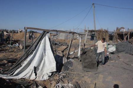 A Palestinian surveys the scene following Israeli air strikes in the southern Gaza Strip town of Rafah October 22, 2009.