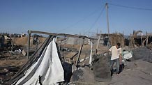 A Palestinian surveys the scene following Israeli air strikes in the southern Gaza Strip town of Rafah October 22, 2009.