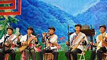 Performers of Lisu ethnic group play folk musical instruments during a show in Lisu Autonomous County of Weixi, southwest China's Yunnan Province, on October 22, 2009.