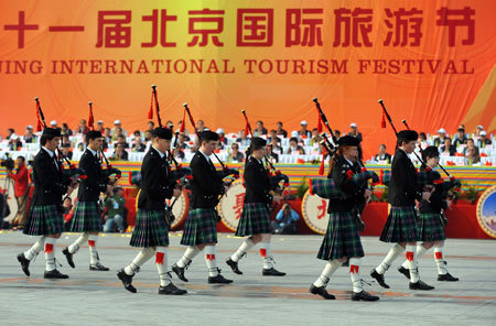 Performers from Britain play bagpipes during a parade at the Olympic Park in Beijing, capital of China, on October 23, 2009. The 11th Beijing International Tourism Festival opening on Friday brought together about 3000 performers from 71 countries and regions, as well as 18 disctricts and counties of Beijing.