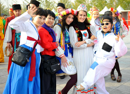 Performers from different countries and regions pose for a group photo before the performance at the Olympic Park in Beijing, capital of China, on October 23, 2009.