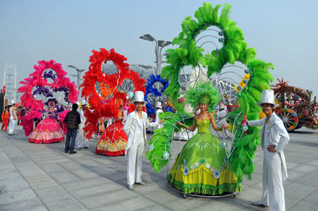 Performers wait for the floats parade at the Olympic Park in Beijing, capital of China, on October 23, 2009. 
