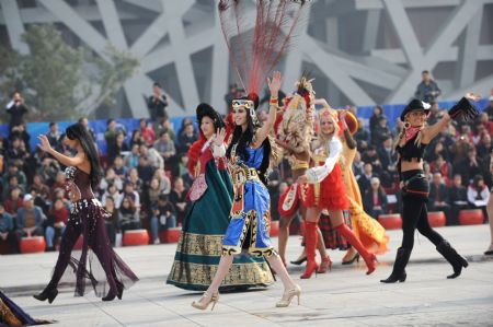 International performers dance during a parade at the Olympic Park in Beijing, capital of China, on Oct. 23, 2009. The 11th Beijing International Tourism Festival opening here on Friday brought together about 3000 performers from 71 countries and regions, as well as 18 disctricts and counties of Beijing.