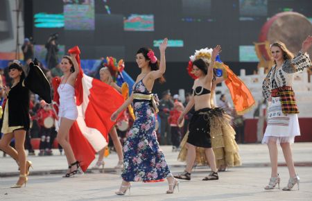 International performers dance during a parade at the Olympic Park in Beijing, capital of China, on October 23, 2009. 