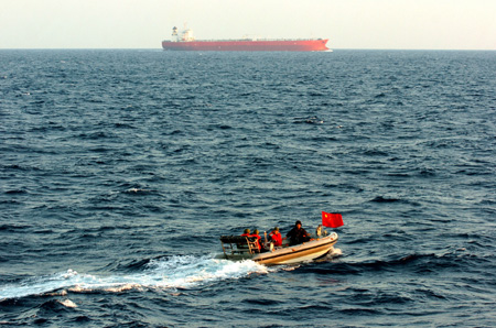 Chinese navy special forces members of &apos;Zhoushan&apos; missile frigate prepare to patrol by a speed boat at sea, October 23, 2009. The third Chinese fleet for an escort mission against pirates escorted 18 merchant vessels on the Gulf of Aden Saturday afternoon and deployed speed boats to patrol for the first time during the escort mission.