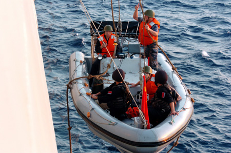 Chinese navy special forces members of &apos;Zhoushan&apos; missile frigate prepare to patrol by a speed boat at sea, October 23, 2009.