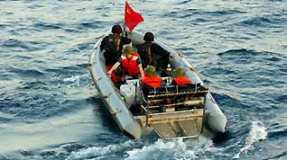 Chinese navy special forces members of 'Zhoushan' missile frigate prepare to patrol by a speed boat at sea, October 23, 2009.