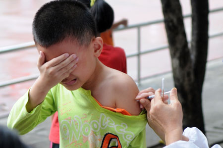 A child receives the A/H1N1 influenza vaccination in Liuzhou, a city in south China's Guangxi Zhuang Autonomous Region, October 28, 2009.