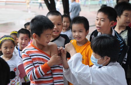 Children receive the A/H1N1 influenza vaccination in Liuzhou, a city in south China's Guangxi Zhuang Autonomous Region, October 28, 2009.