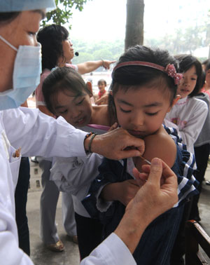 Children receives the A/H1N1 influenza vaccination in Liuzhou, a city in south China's Guangxi Zhuang Autonomous Region, October 28, 2009. 