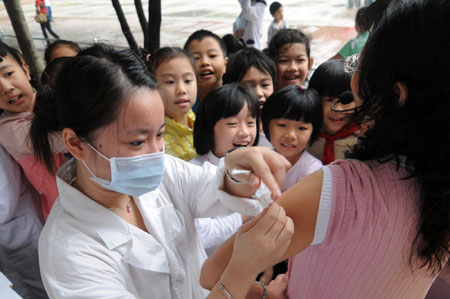 A teacher receives the A/H1N1 influenza vaccination in Liuzhou, a city in south China's Guangxi Zhuang Autonomous Region, October 28, 2009.