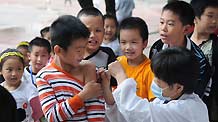 Children receive the A/H1N1 influenza vaccination in Liuzhou, a city in south China's Guangxi Zhuang Autonomous Region, October 28, 2009.