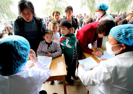 Teachers and students get the A/H1N1 influenza vaccination in turns from medical staff with local center for disease control and prevention, at Yuncheng City, north China's Shanxi Province, October 28, 2009. 