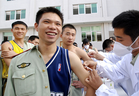 Armed policemen with the Chinese People's Armed Police Forces Fujian Provincial Corps get the A/H1N1 influenza vaccination in turn from medical staff with local center for disease control and prevention, at Fuzhou City, southeast China's Fujian Province, October 28, 2009.