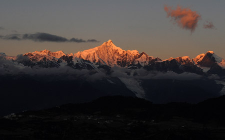 The Meili Snow Mountain is illuminated by sunlight in Deqin county, Diqing Tibetan Autonomous Prefecture, in southwest China's Yunnan Province, on October 27, 2009.