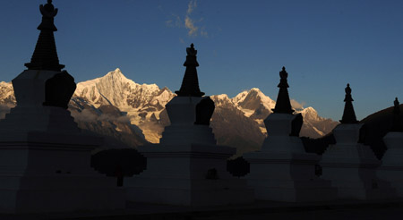 Photo taken on October 27, 2009 shows the Meili Snow Mountain behind a row of pagodas in Deqin county, Diqing Tibetan Autonomous Prefecture, in southwest China's Yunnan Province. 