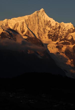 The Meili Snow Mountain is illuminated by sunlight in Deqin county, Diqing Tibetan Autonomous Prefecture, in southwest China's Yunnan Province, on October 27, 2009.