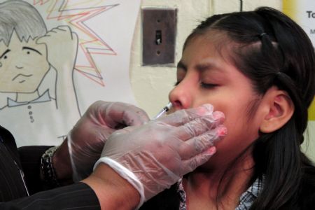 A student receives a free H1N1 flu vaccine at the 157 Public Elementary School in New York, the United States, October 28, 2009. New York City began its school-based H1N1 influenza vaccination campaign on Wednesday. The frist phase of the three-stage initiative started at 125 schools with enrollment of less than 400.